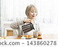 A senior woman's breakfast of freshly baked bread 143860278