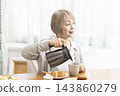 A senior woman's breakfast of freshly baked bread 143860279