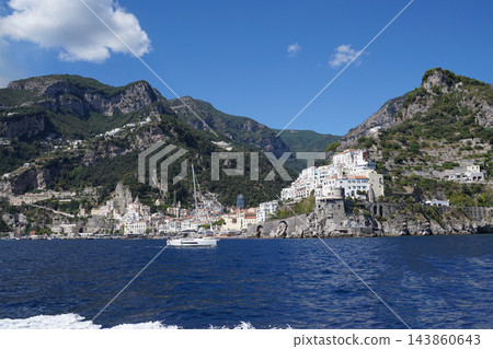 View of beautiful Amalfi town, Campania, Italy. Amalfi coast is most popular travel and holiday destination in Europe. Amalfi cityscape on coast line of mediterranean sea - view from sea 143860643