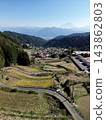 Terraced rice fields in Hirabayashi, Fujikawa Town, Yamanashi Prefecture, with a view of Mt. Fuji: Autumn rural landscape 143862803