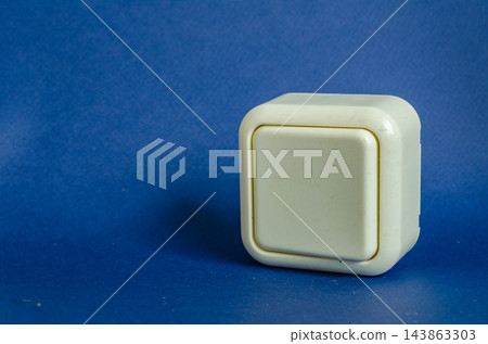 White wall switch on a blue surface in a studio setting White wall switch on a blue surface in a studio setting 143863303