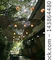 A riverside terrace surrounded by fresh greenery and traditional Japanese lanterns 143864480