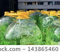 Large plastic containers. Automotive fluids, chemicals, or bulk liquids in a retail or warehouse setting. 143865460