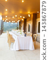 Blurred festive dining table on a warmly lit terrace 143867879