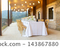 Outdoor dining table with string lights for an elegant celebration 143867880