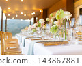 Elegant wedding reception table with floral centerpieces and glassware 143867881