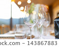 Empty wine glasses arranged for an elegant fine dining table setting 143867883