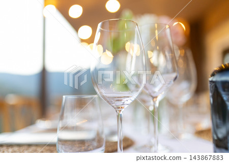 Empty wine glasses arranged for an elegant fine dining table setting 143867883