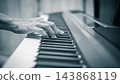 male musician hands on piano keys, monochrome, music background 143868119