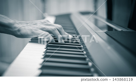 male musician hands on piano keys, monochrome, music background male musician hands on piano keys, monochrome, music background 143868119