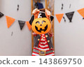 Child in pirate costume holding pumpkin bucket for Halloween trick or treat 143869750