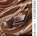 Chocolate pieces on glossy melted cocoa butter swirl 143869988