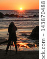Person watching the sunset 143870488