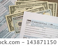 Tax form 1040 U.S. Individual Income Tax Return with dollar banknotes money. 143871150