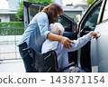 Caregiver help Asian elderly woman disability patient use wheelchair to get in car. 143871154