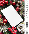 Blank christmas greeting card framed by festive evergreen decorations 143871190
