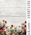 Christmas greenery and ornaments framing a whitewashed wooden background 143871192