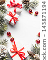 Christmas gifts and red ornaments on a frosted evergreen border with copy space 143871194