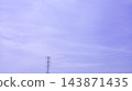 Pale sky holds faint clouds. Power lines stretch across the frame. Tower stands tall, stark against the light. Silent scene evokes calm, quiet energy. Ideal for modern, minimalist design projects 143871435