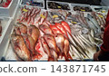 A variety of fresh fish on display at the fish market, and scenes of them being sold on ice. 143871745