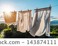 Fresh Laundry Drying on Clothesline in Sunlight 143874111