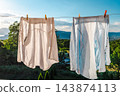 White Laundry Hanging Against Mountain Lake Landscape 143874113