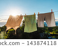 Laundry Drying on Clothesline in Warm Evening Sunlight 143874118