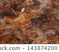 Rust-colored volcanic rock surface, reddish-brown textured background 143874200