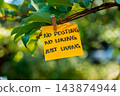 Paper note reading NO POSTING NO LIKING JUST LIVING attached to leafy green plant. Suitable for digital detox, screen-free lifestyle technology 143874944