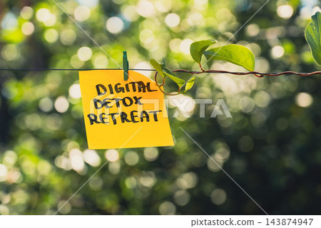 Paper note with DIGITAL DETOX RETREAT message against green leafy background. Suitable for digital detox, screen-free lifestyle technology break mindfulness. Paper note with DIGITAL DETOX RETREAT message against green leafy background. Suitable for digital detox, screen-free lifestyle technology break mindfulness. 143874947