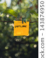 Paper note reading OFFLINE attached to leafy green plant. Suitable for digital detox, screen-free lifestyle technology 143874950