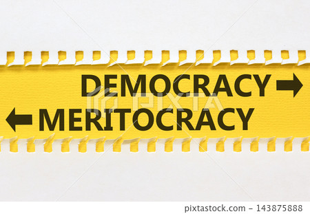 Democracy or meritocracy words symbol. Concept words Democracy Meritocracy on beautiful yellow paper. Beautiful white background. Business democracy meritocracy concept. Copy space Democracy or meritocracy words symbol. Concept words Democracy Meritocracy on beautiful yellow paper. Beautiful white background. Business democracy meritocracy concept. Copy space 143875888
