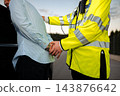Police officer detaining a man during roadside arrest 143876642