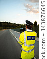 Police officer monitoring highway traffic with a speed camera 143876645
