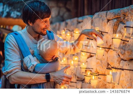 Father sharing a traditional candle experience with his infant son. Father sharing a traditional candle experience with his infant son. 143876874