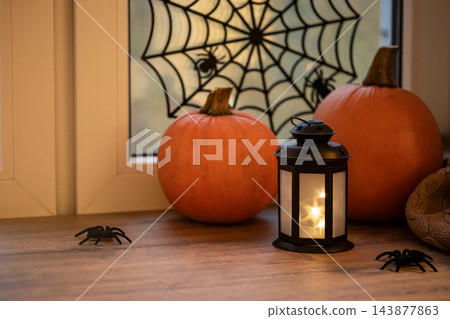 Halloween pumpkins with glowing lantern and spiderweb 143877863