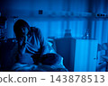 Hospital patient seeks family contact. Individual in hospital calls loved ones late at night. Hospitalized figure uses phone to reach out to support during lonely hours 143878513