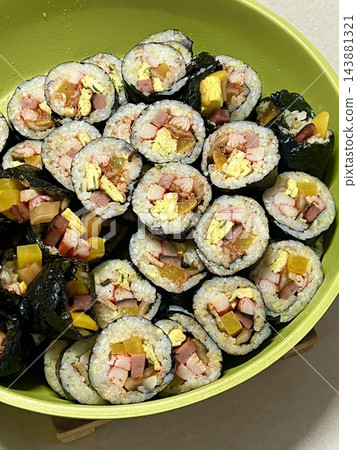 Delicious kimbap rolls filled with fresh vegetables, seasoned rice, and savory proteins, all wrapped in crisp seaweed. A perfect combination of flavor and texture in every bite. 143881321