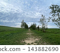 Kamifurano Town, Hokkaido: A straight road running through the hills and breathtaking scenery with its ups and downs. 143882690