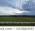 Kamifurano Town, Hokkaido: A straight road running through the hills and breathtaking scenery with its ups and downs. 143882691