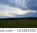 Kamifurano Town, Hokkaido: A straight road running through the hills and breathtaking scenery with its ups and downs. 143882692