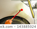 Removing dents on the car. PDR technology. Car body repair without painting. 143885024