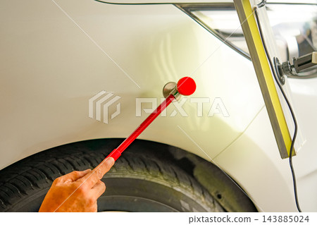 Removing dents on the car. PDR technology. Car body repair without painting. Removing dents on the car. PDR technology. Car body repair without painting. 143885024