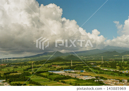Towering White Clouds Over Green Jeju Countryside 143885969