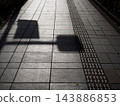 Shadows of streetlights cast on the sidewalk 143886853