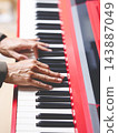 close up male musician hands playing on red piano. music background 143887049