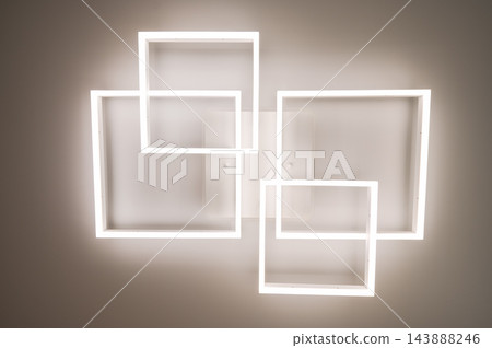 Geometric ceiling light with glowing square frames, bottom view of modern LED fixture Geometric ceiling light with glowing square frames, bottom view of modern LED fixture 143888246