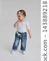 Toddler Girl in Denim Jeans Standing in Studio 143889218
