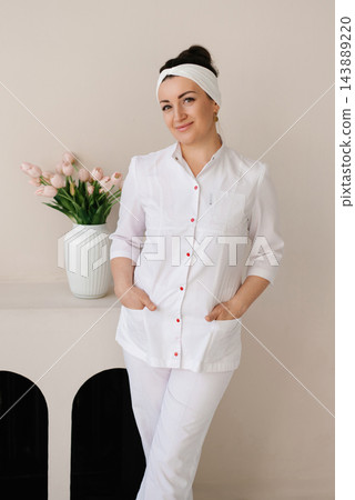 Professional Woman Physician Posing in Stylish Office Professional Woman Physician Posing in Stylish Office 143889220