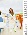 Customer Looking at Camera in Shopping Center 143889222